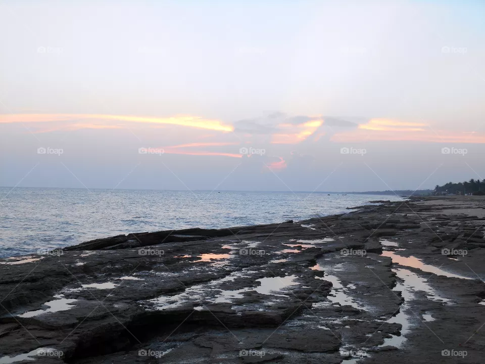 Sea shore rock and sun set