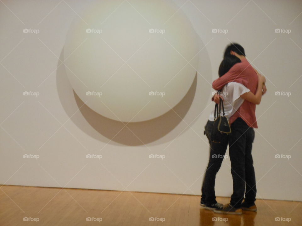 young love . I was at a museum and saw this couple hug in front of a piece of art