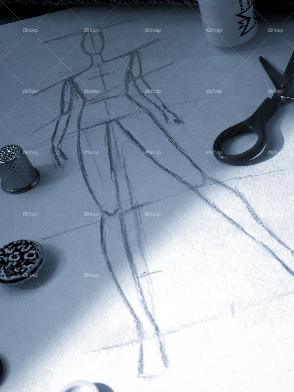 Sketch of a human body on a sheet of paper, buttons, scissors