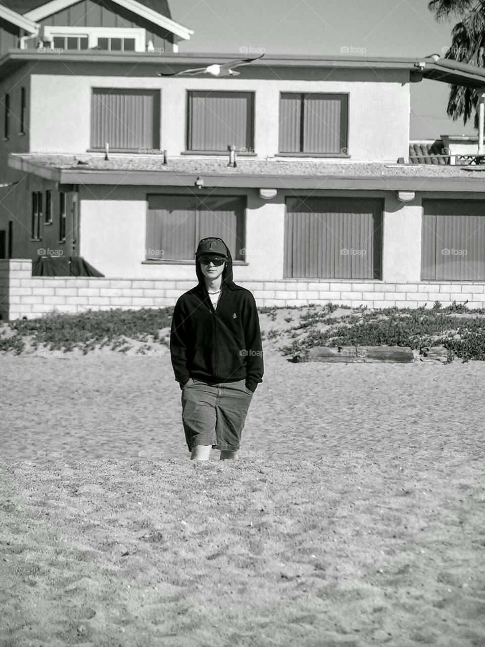 Man walking on sand against building