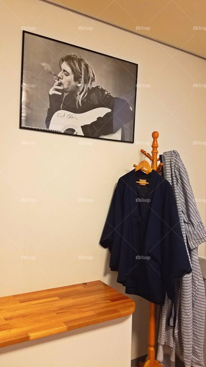 Kimono in the hanger and rock star poster on the wall