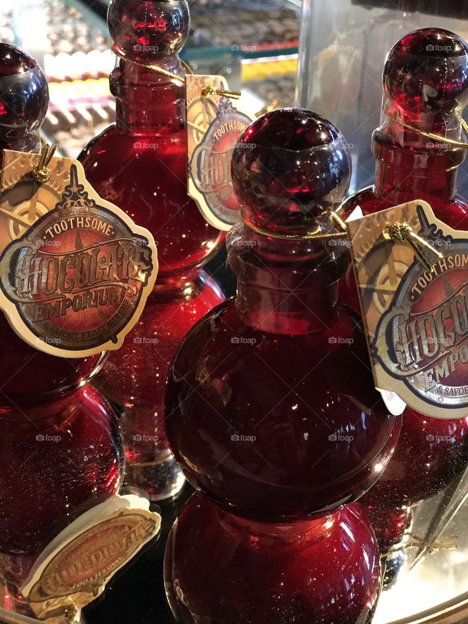 Deep red bottles reflecting onto mirror