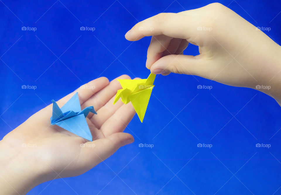 The child holds the origami cheering