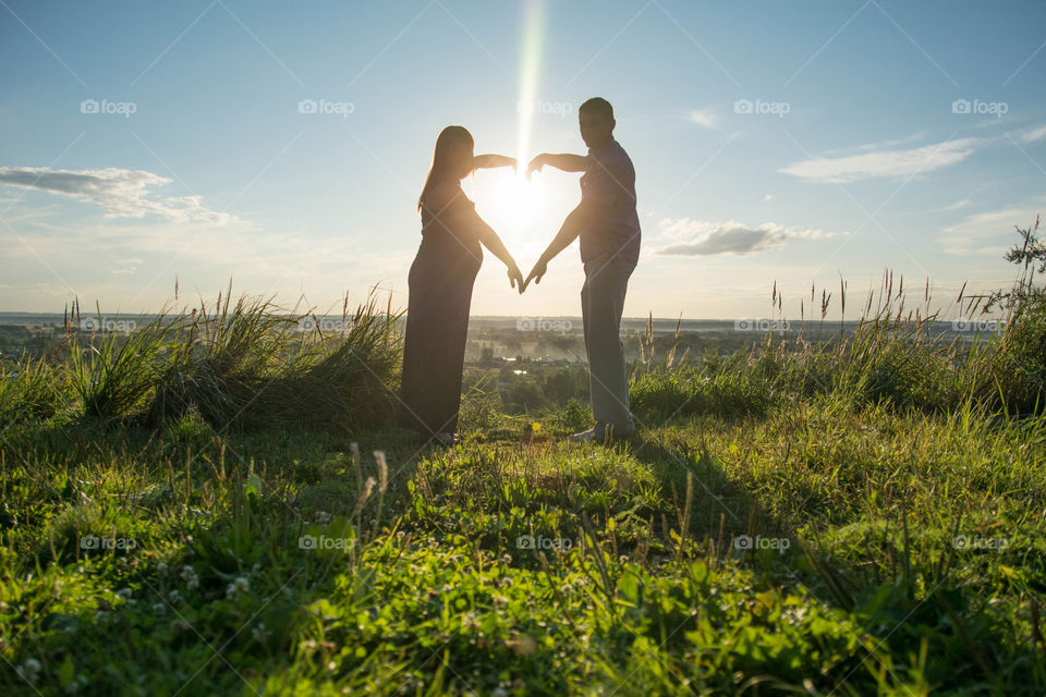 Husband and wife are staying in sun rays