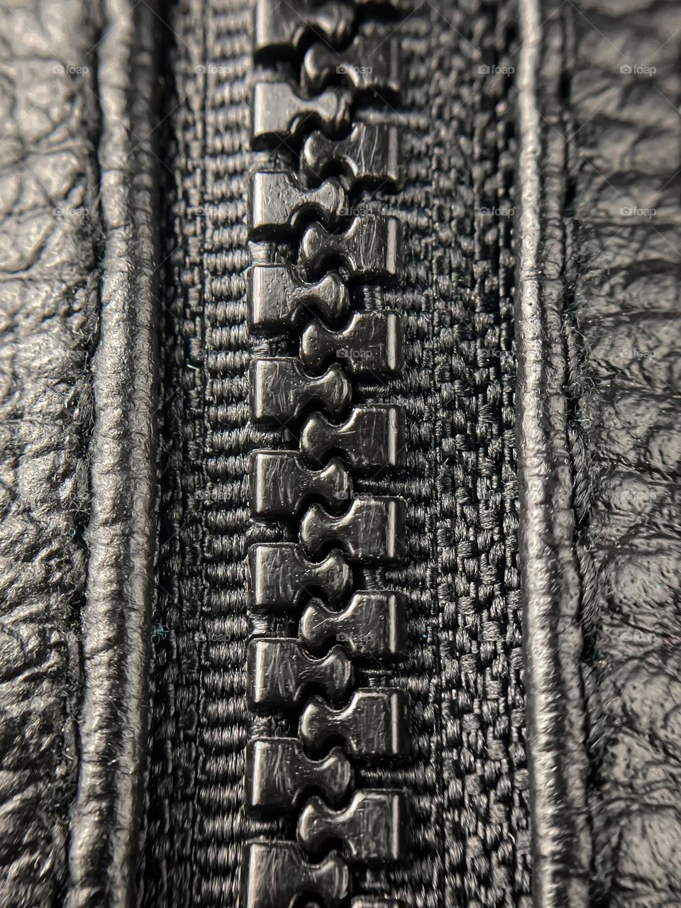 A zip on a black leather jacket