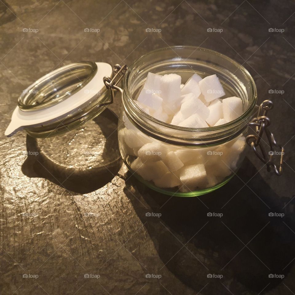 Glass jar with sugar cubes.