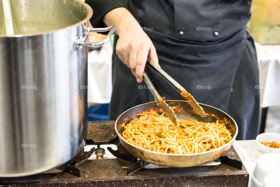 Chef In The Hotel Kitchen Restaurant Prepares Pasta Macaroni
