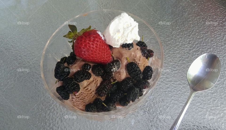 chocolate ice cream with berries and whipped topping