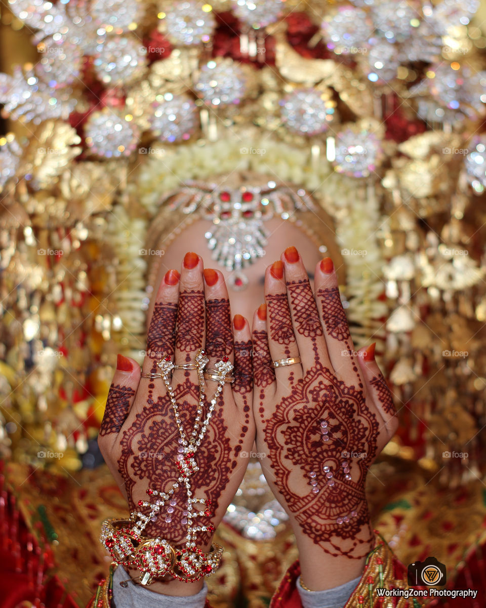 henna, is a series of customs that must be done by minang kabau tribe, west sumatera. Indonesia, this ritual signifies that women have been married by men. the installation of henna is witnessed by both families.