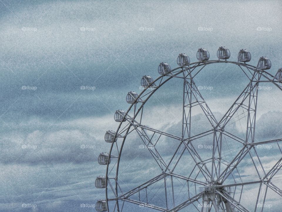 a ferris wheel with the sky in the background