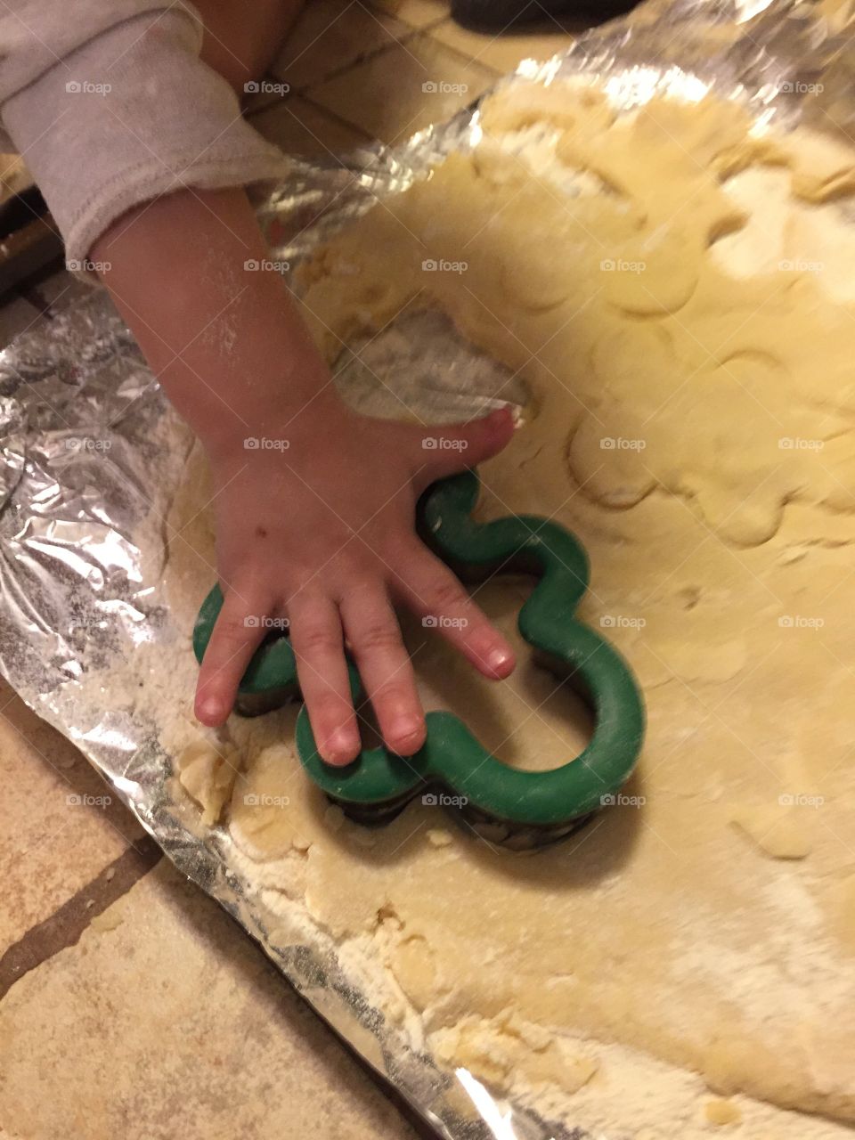 Grandson helping me make sugar cookie with cookie cutter 