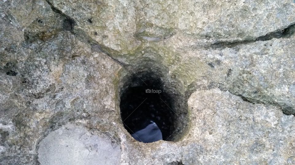 Rock hole over water
