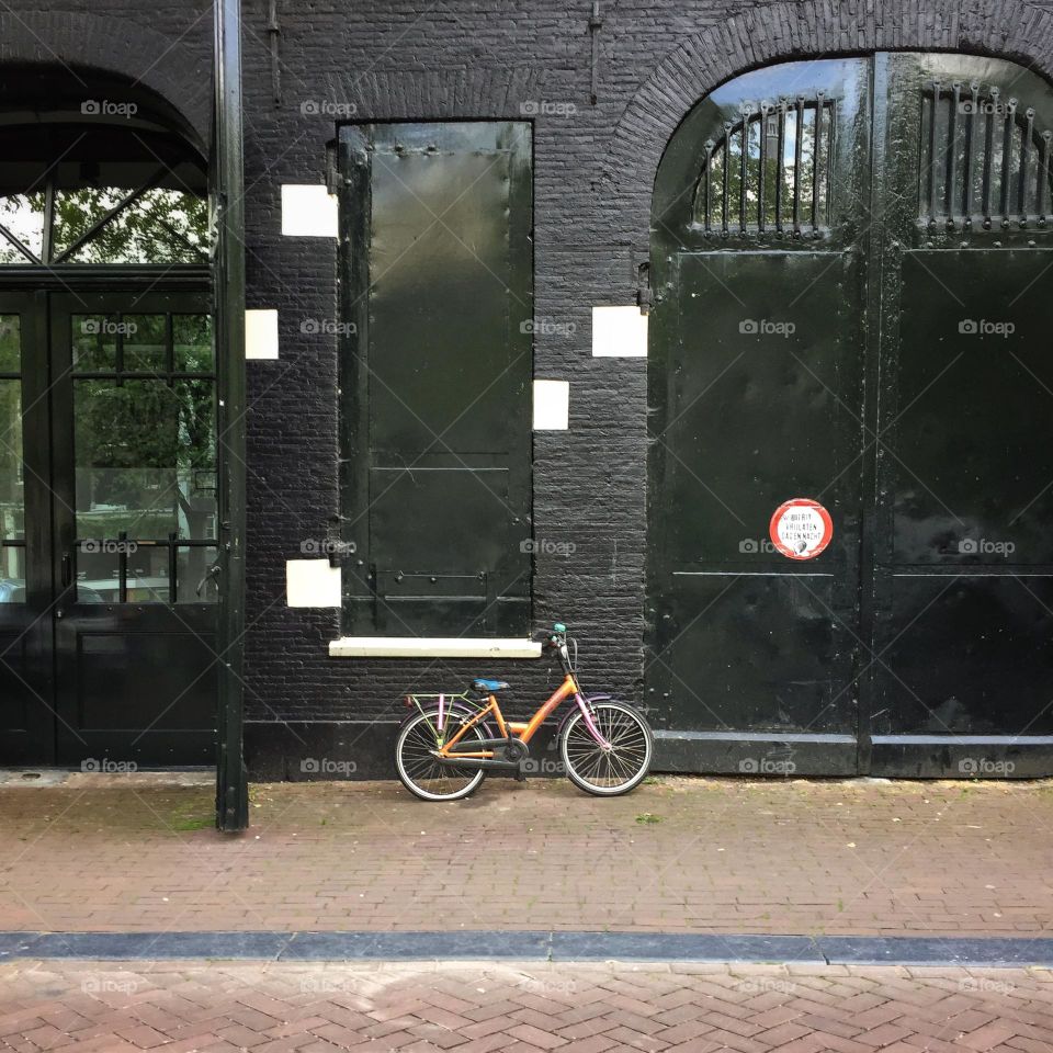 Bicycle against a black wall