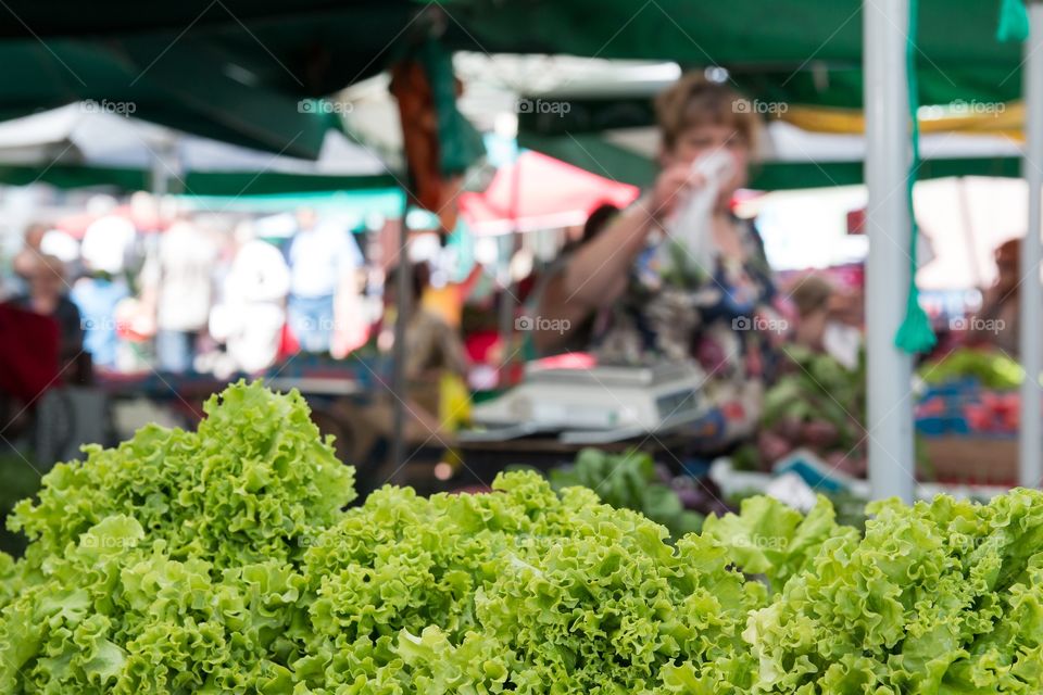 Woman selling vegetables in marketplace