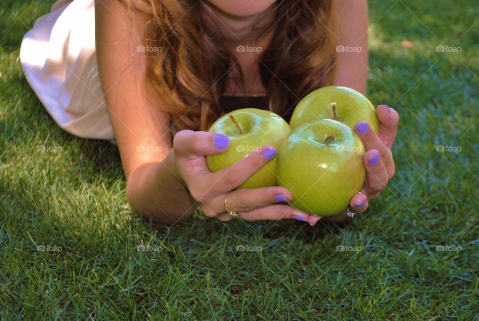 green apples. girl holding green apples