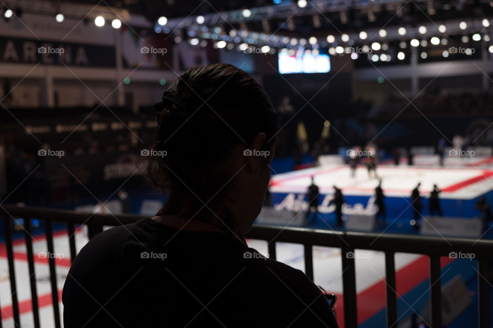 Silhouette of a woman spectator watching Judi in Arena