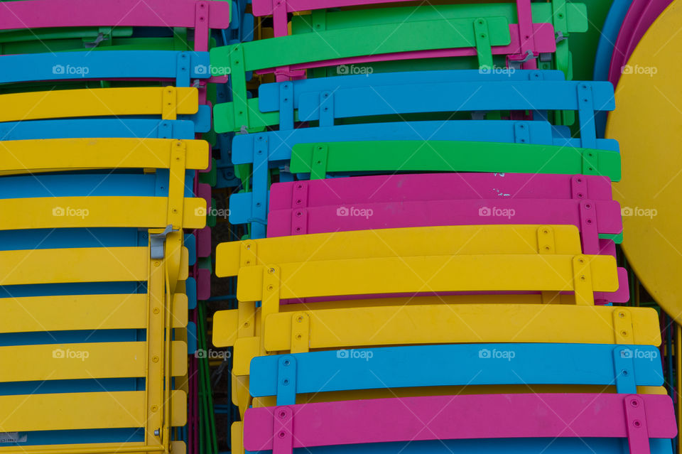 Stacked colorful  chairs 