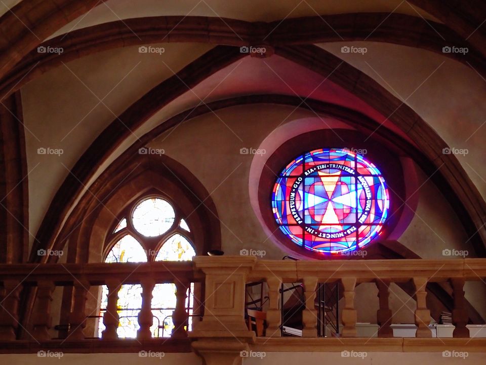 A beautiful stained glass window with vibrant colors in an old cathedral in Luxembourg. 