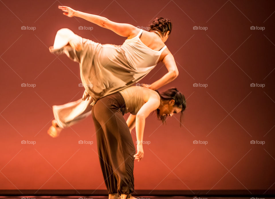 Two Female Modern Dancers Doing Acrobatics
