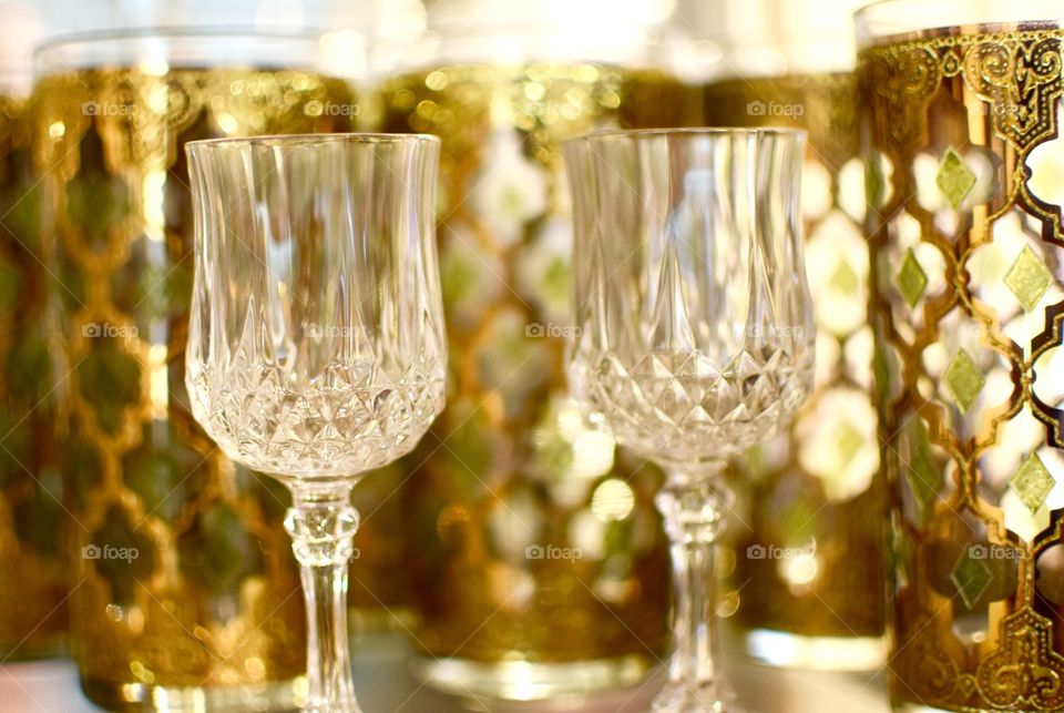 Goblets and glasses of gold on a shelf 