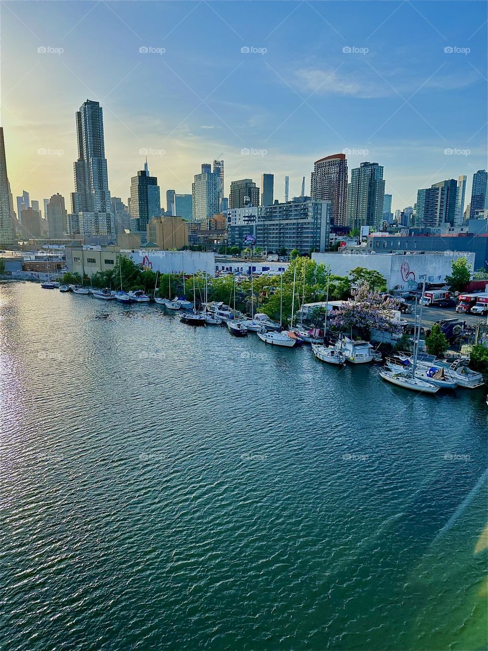 This is “Newtown Creek” seen from the “Pulaski Bridge” that connects “Greenpoint”, Bklyn to LIC, Queens. Across the “East River” in the distance we see the “Manhattan” skyline. 2024. Hypnotic Productions