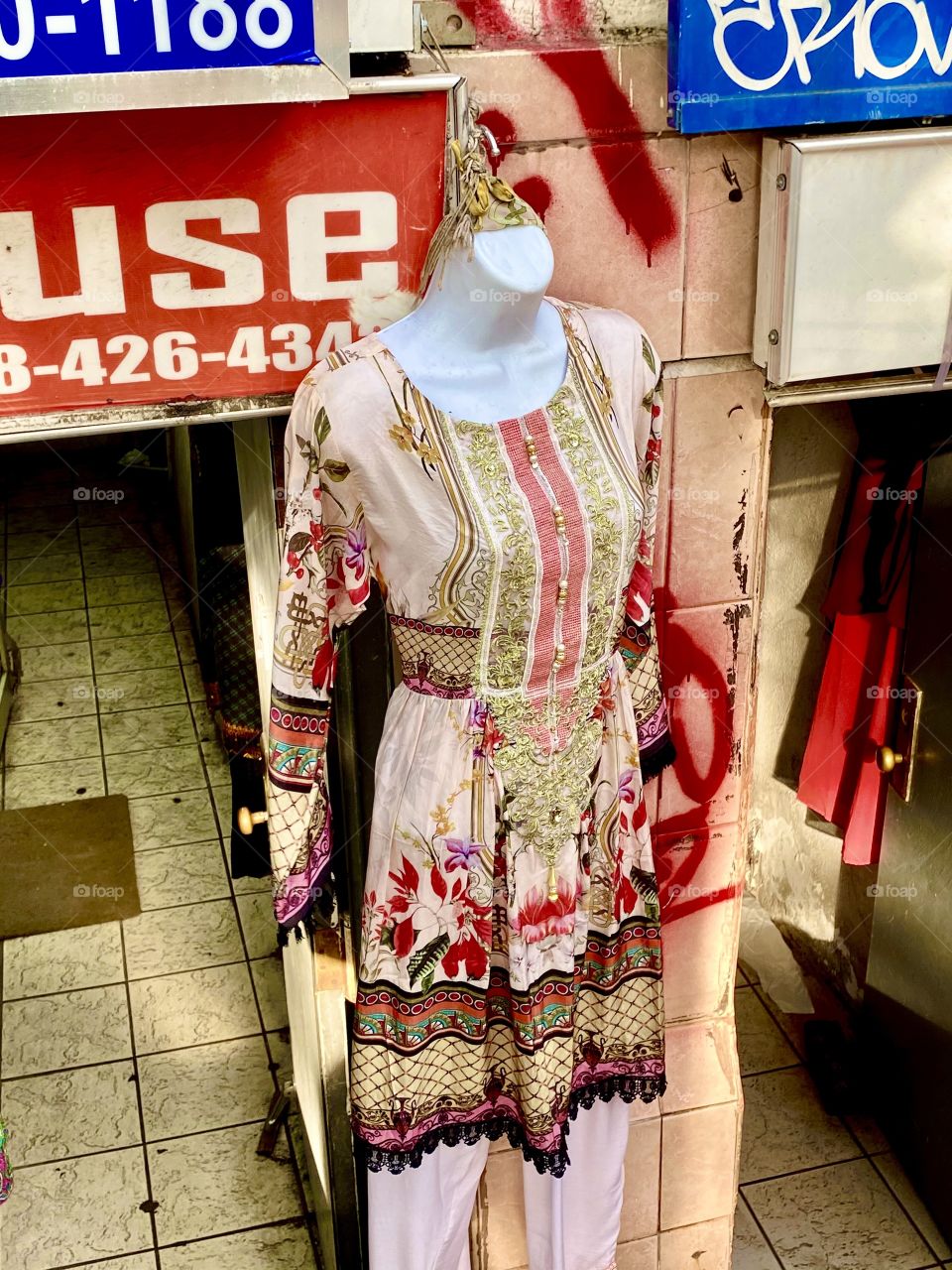 Sari mannequin display outside basement storefront, Jackson Heights, Queens, NYC