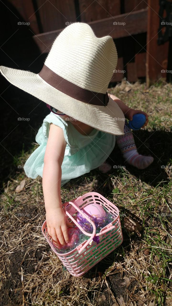 Easter egg hunt toddler finding eggs hidden outside