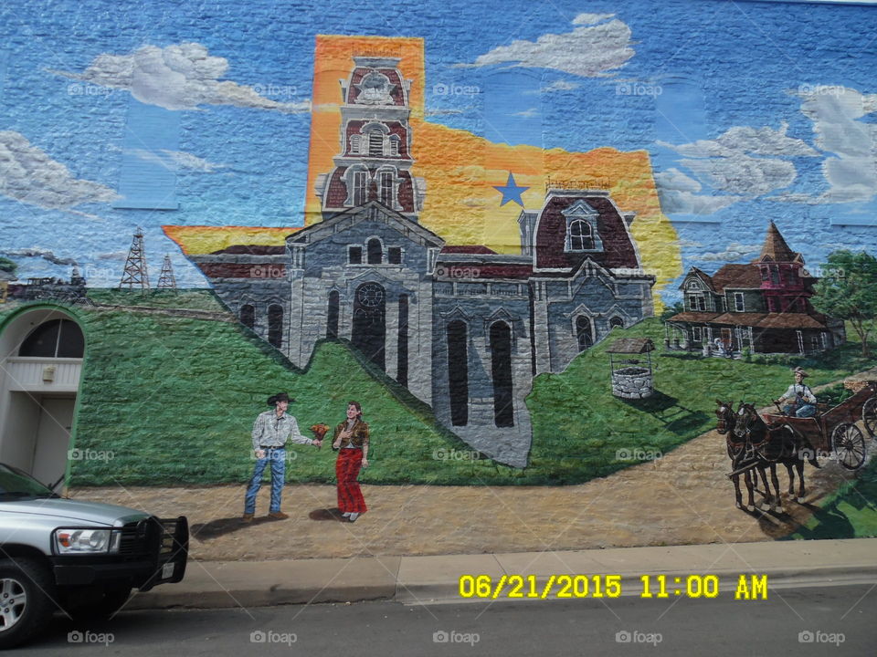 Texas size Muriel 2. this is another view of the same western scene painted on this building that is located in Weatherford Texas