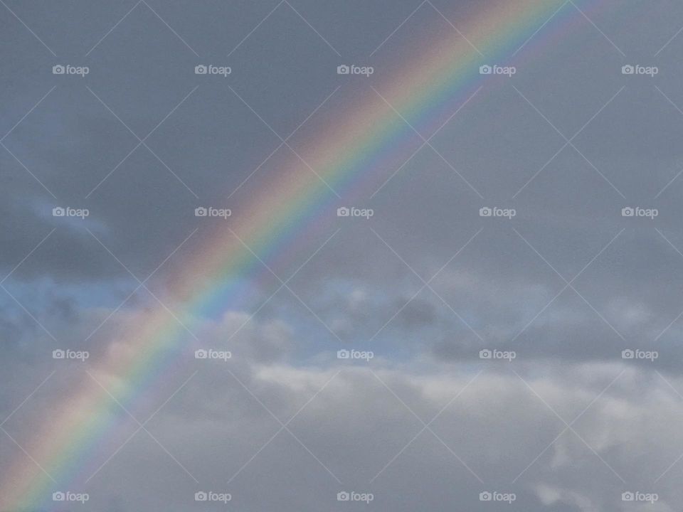 Clear rainbow high in the sky