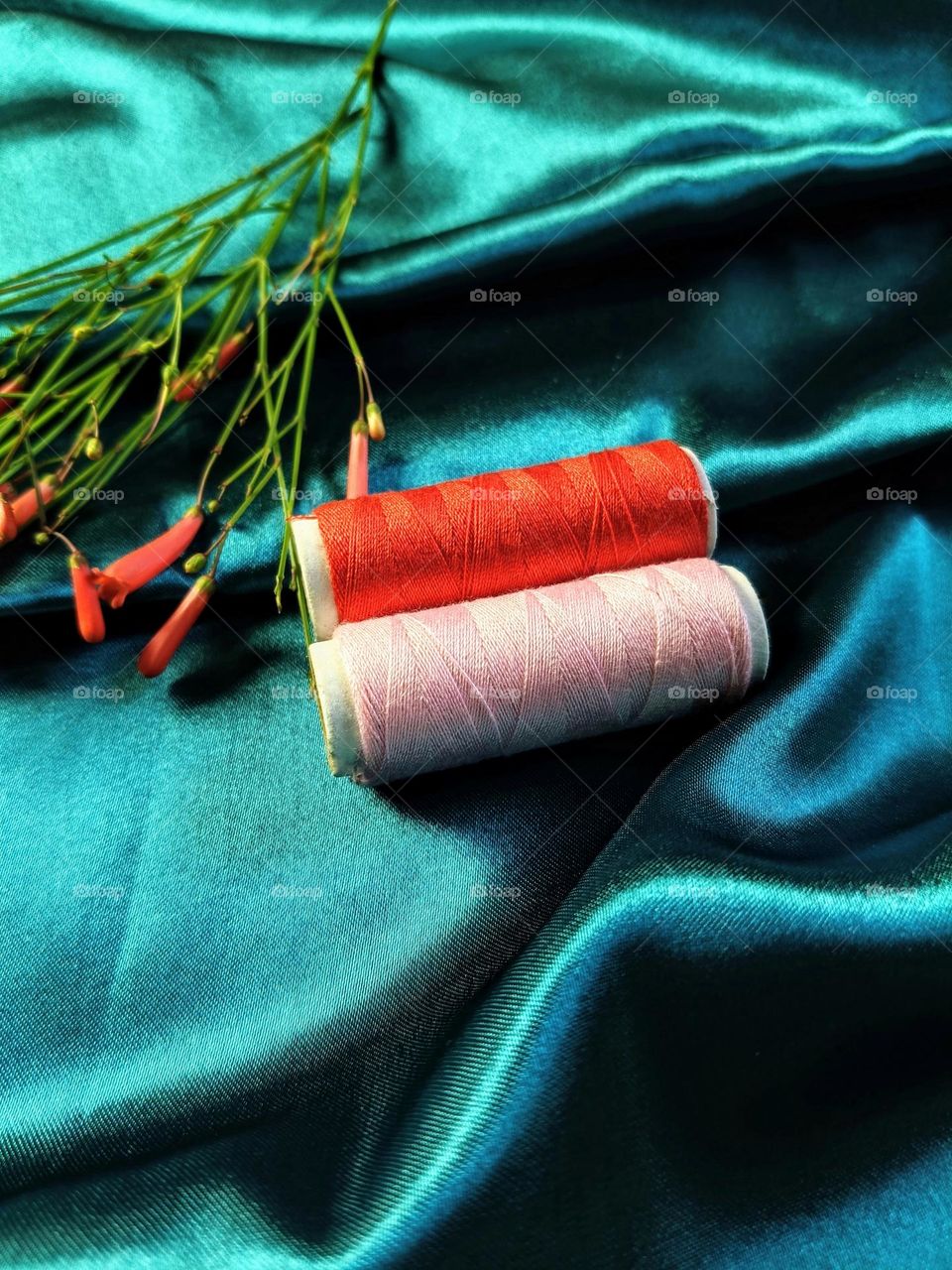 Two rolls of thread on the cloth.
