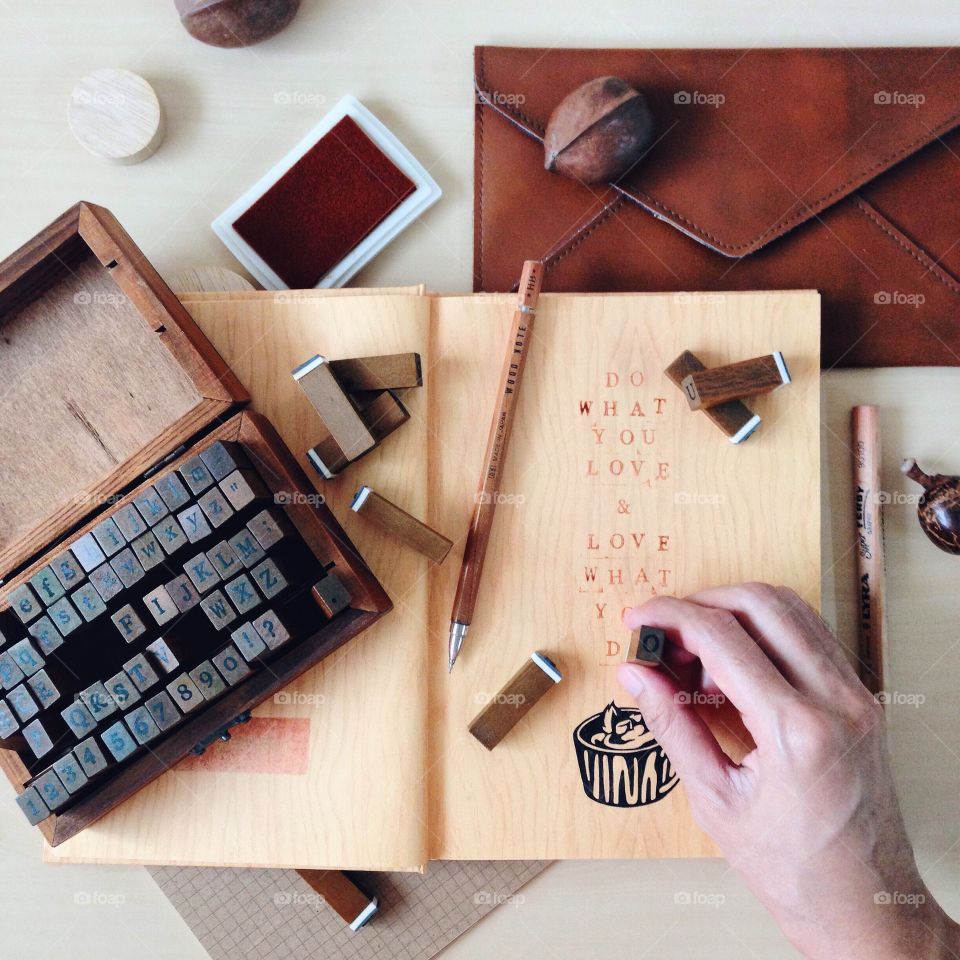 Working Desk from Above : quote stamping "Do what you love & love what you do"