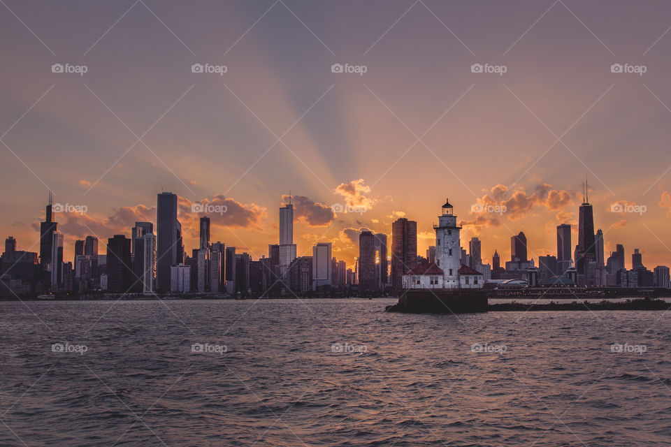 View of lighthouse and city during sunrise
