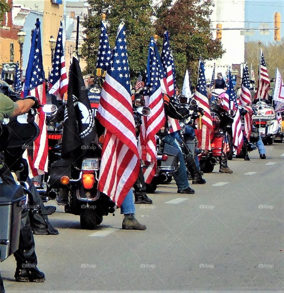 Bikers ride with the red, while and blue. These American War Veterans were showing their true colors during the Veterans Day Parade in Ottawa, Kansas. Pride, honor an respect roared as loud as the motorcycle engines.