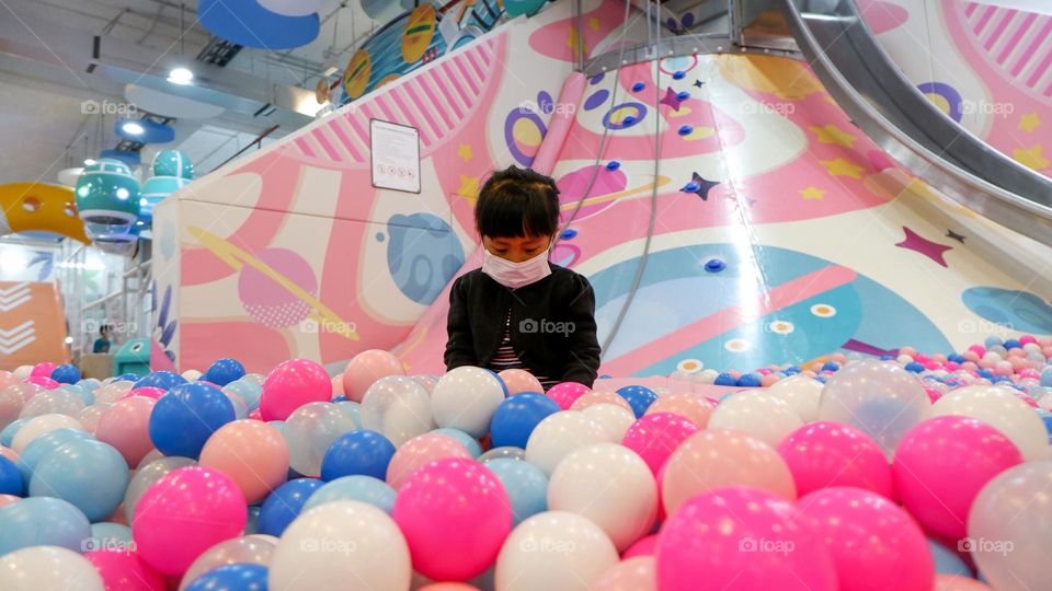 Play in a pool filled with colorful balls at the indoor playground