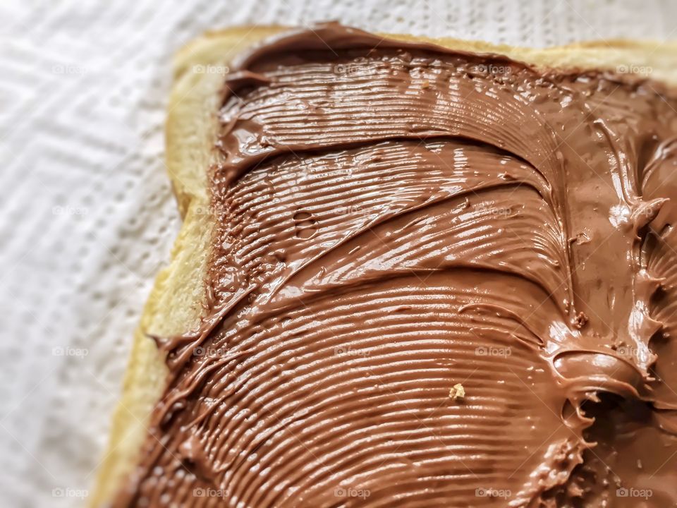 Chocolate cream spread on a slice of bread 