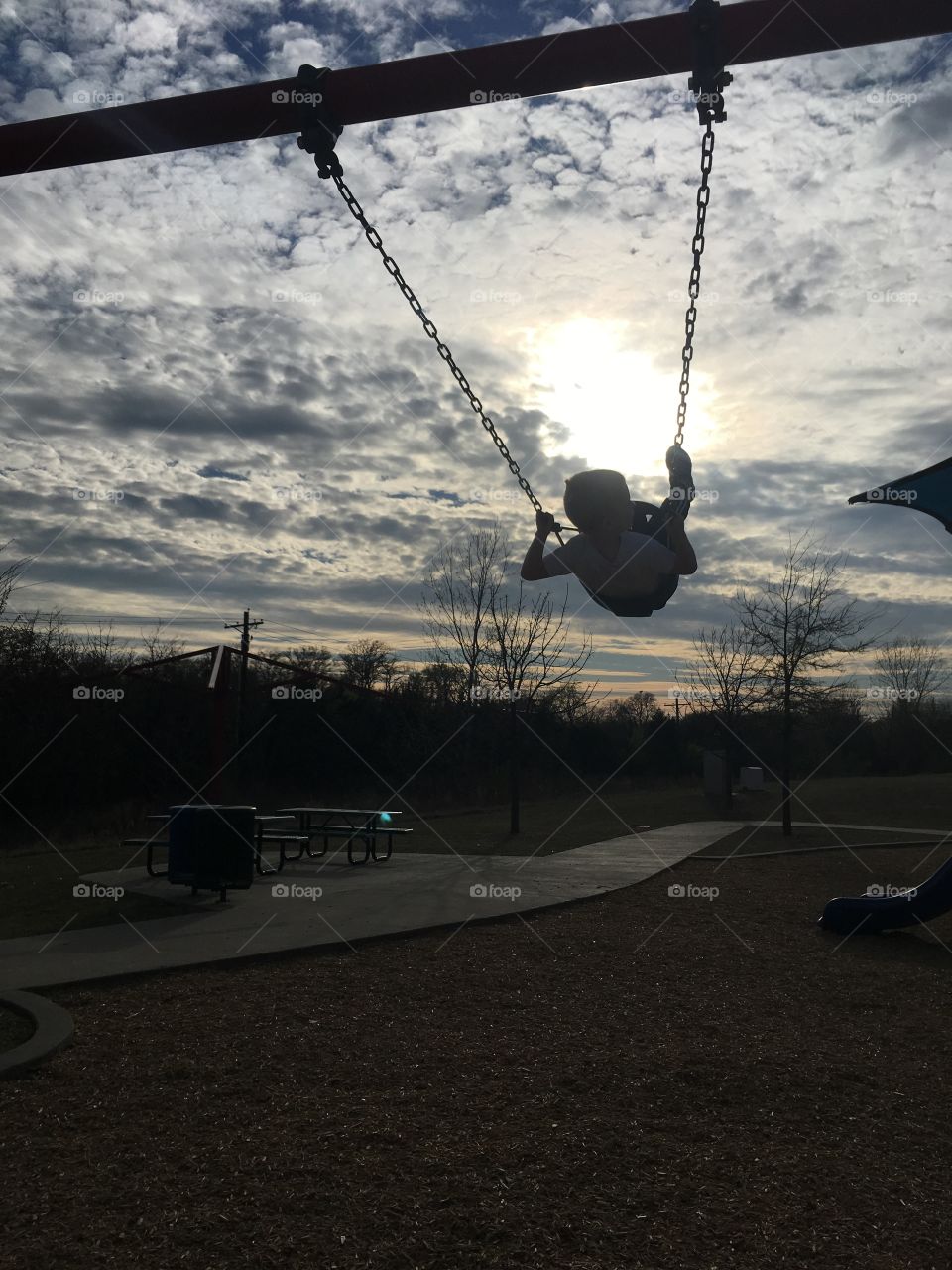 Swinging at the park silhouette 