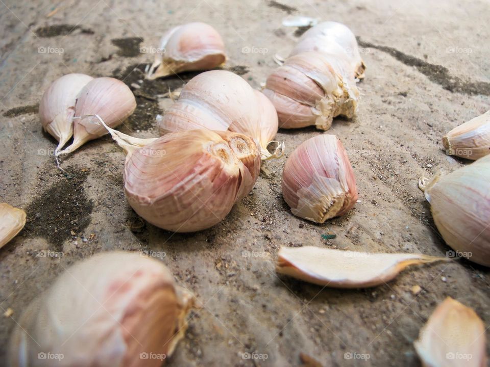 Close-up of whole garlic scattered on the ground