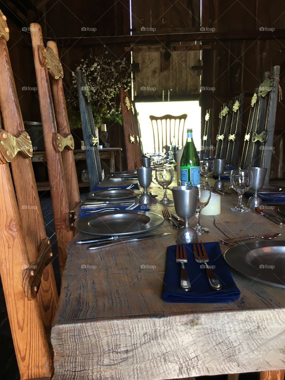 Preparations made for evening dinner, all the silverware and plates are out.  Ready for dinner guests in the lovely rustic barn