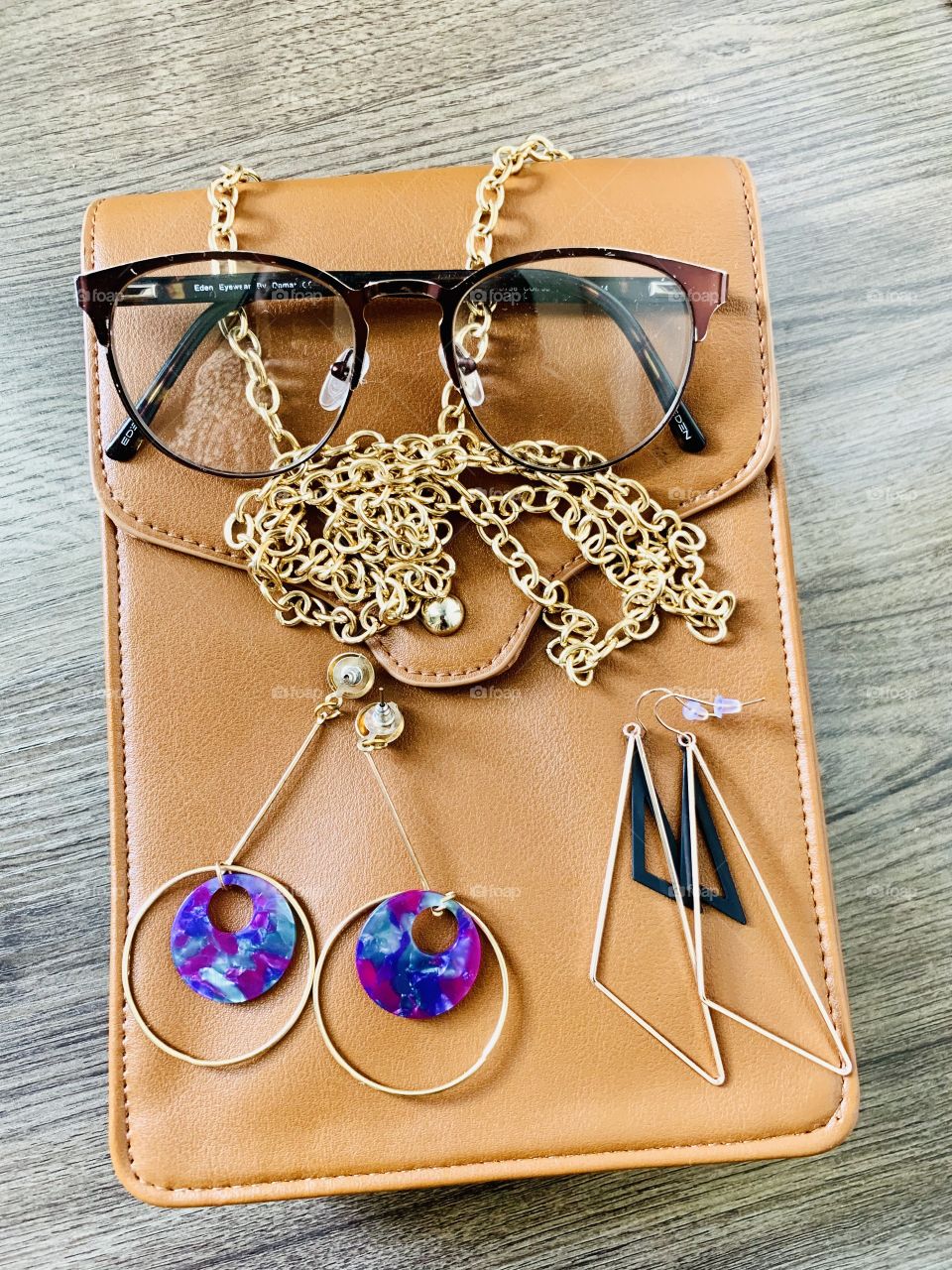 Every girl’s must have. A bunch of accessories: spectacles, earings and a purse. 