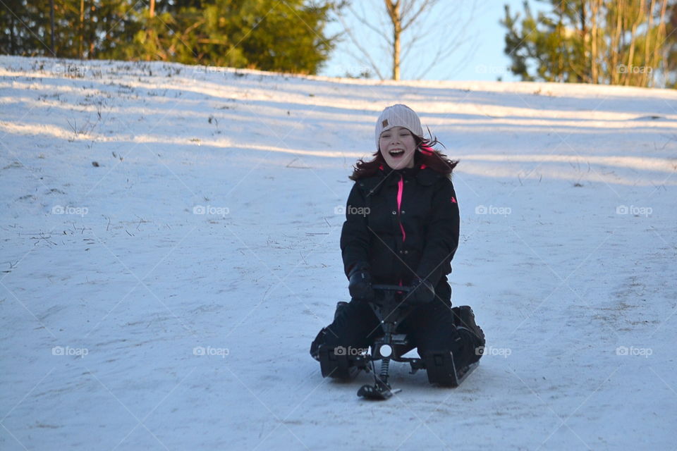 Happy face, girl sledding