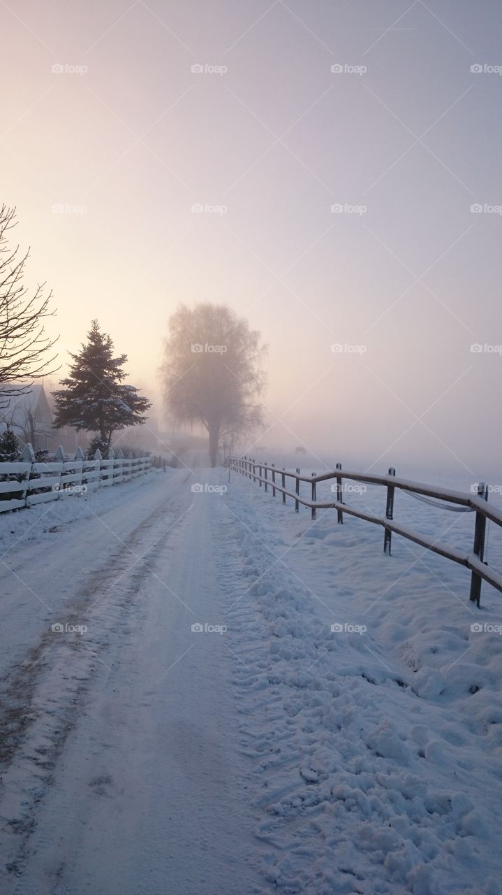 View of snow covered empty road