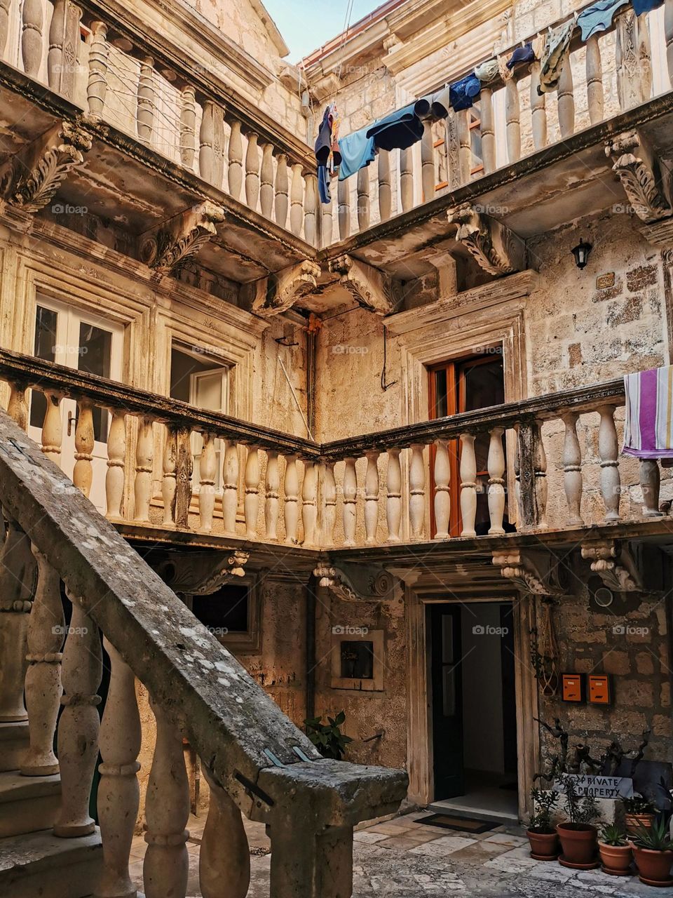 Courtyard of old stone house. Beautiful architecture of an old mediterranean apartment building.