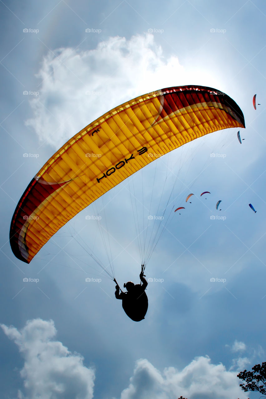 Paragliders silhouette in the sky summer
