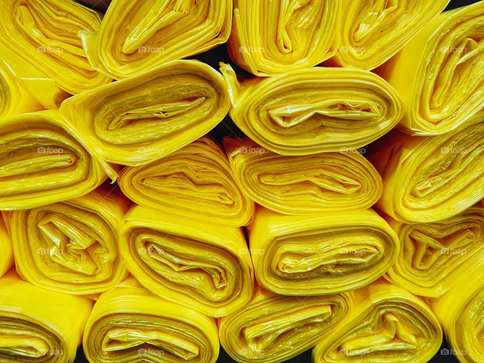 stack of yellow plastic bags