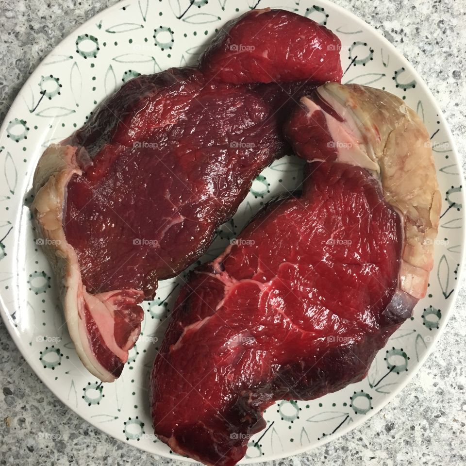 Two rump steaks ready to barbecue 