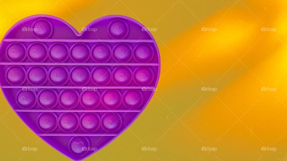 purple pop it on a yellow background