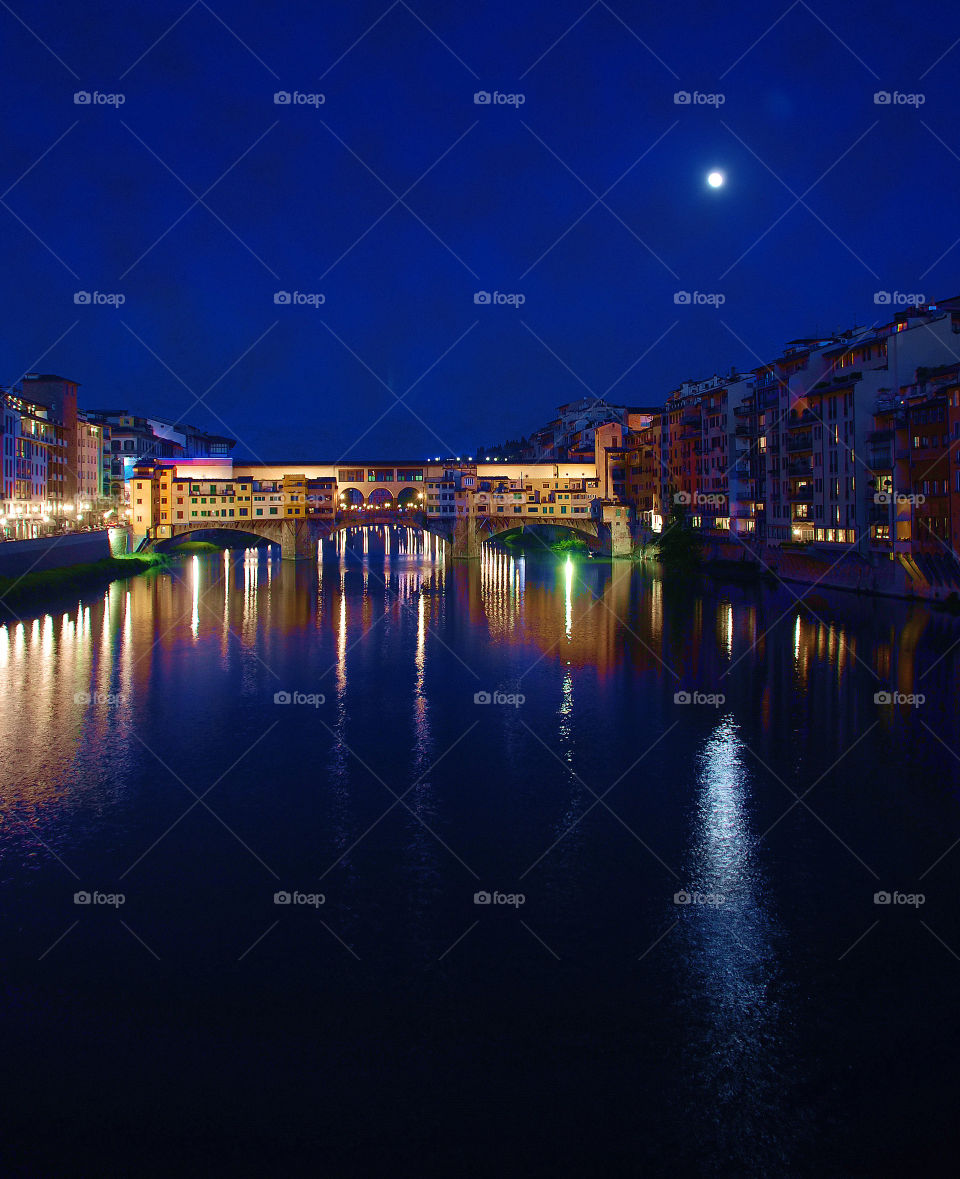 Twilight blue Florence . Moonlight on the Arno River in Florence with the Ponte Vecchio 