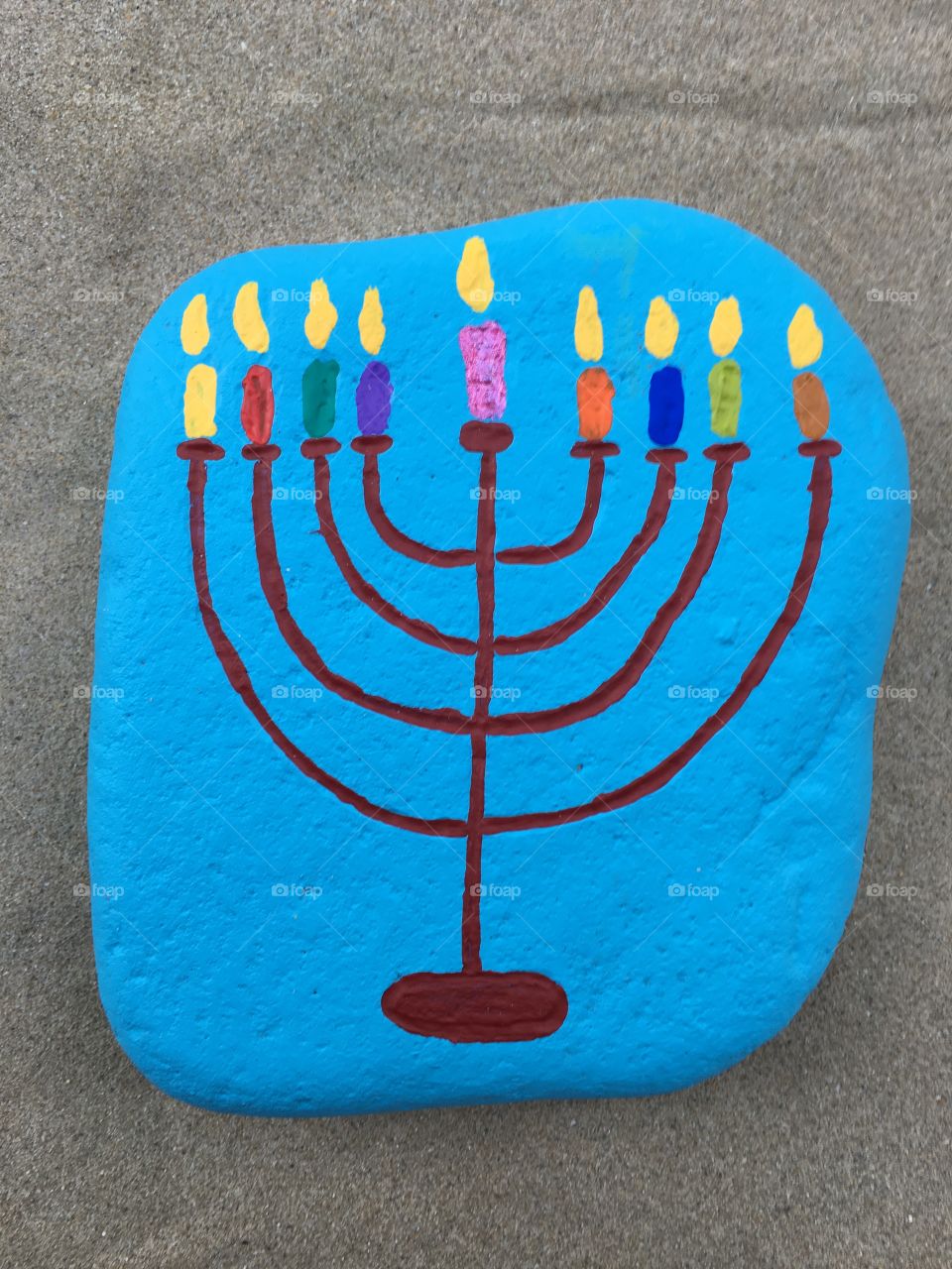 Happy Hanukkah on a carved and colored stone 