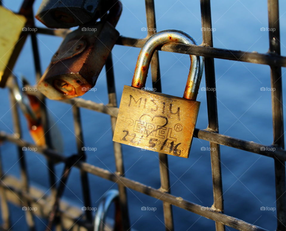 Close-up Of padlock attached on fence