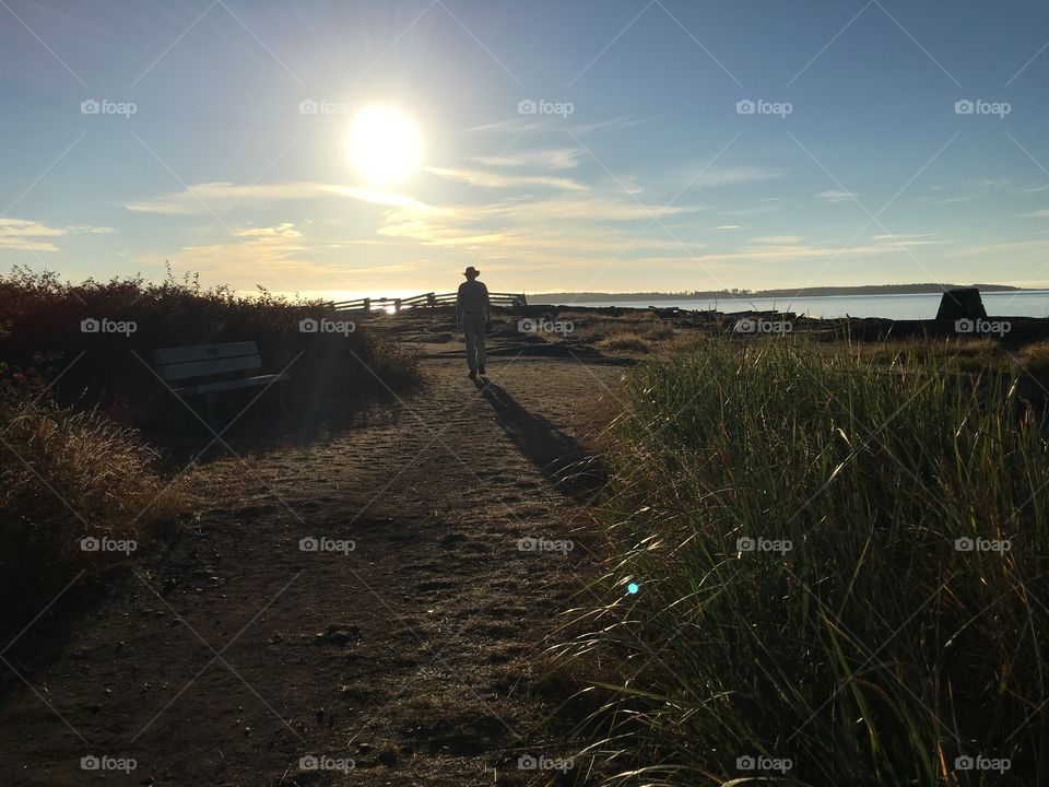 Man walking on sunrise at Cattle Point,  Victoria